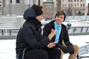 Two people talking on a park bench