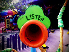A Sign on a Playground that says "listen"