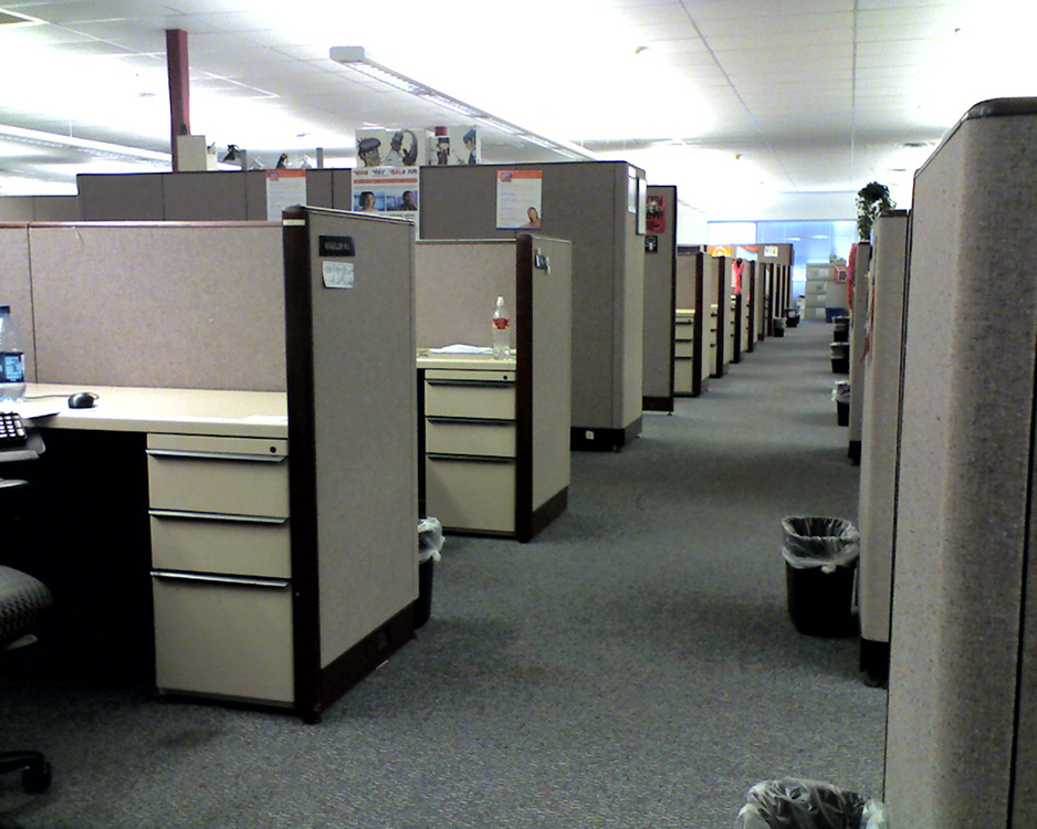 A long line of cubicles is shown.