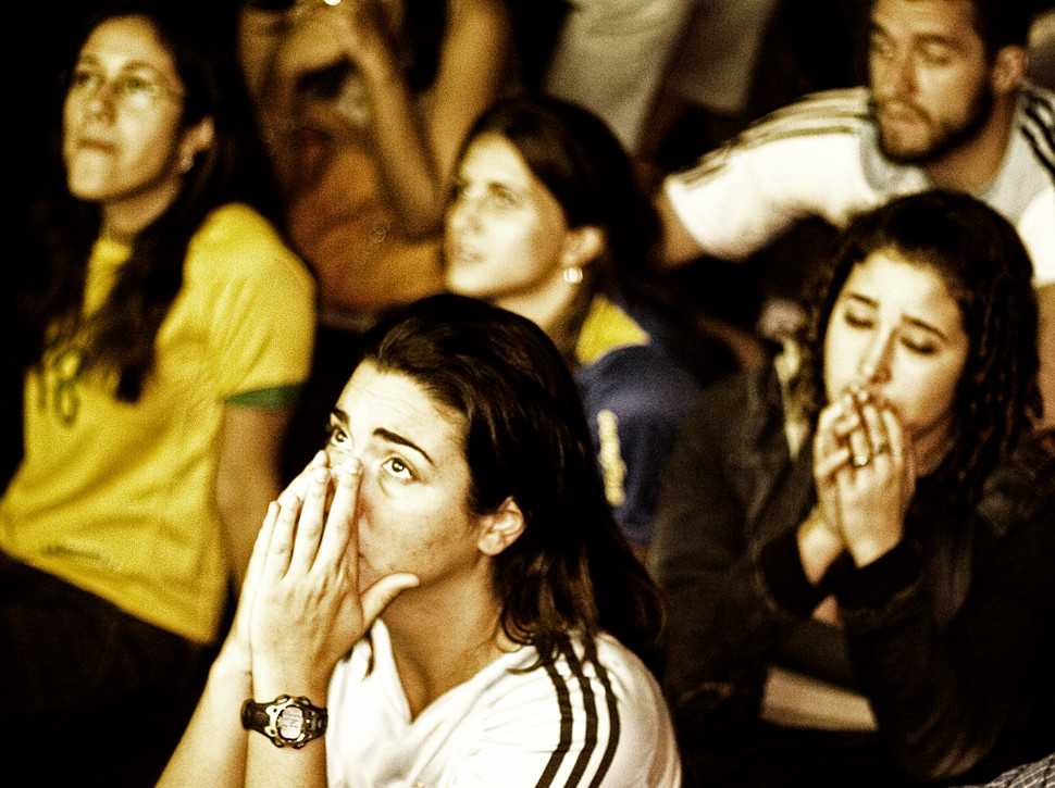 Image of Young Adults Closely Watching a Soccer Match on TV