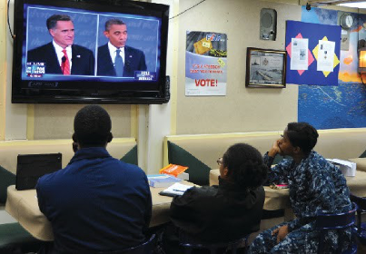 Sailors on the USS McCampbell, based out of Yokosuka, Japan, watch the first presidential debate between President Barack Obama and former Massachusetts governor Mitt Romney on October 4, 2012