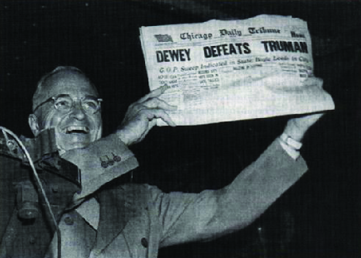 Photo shows Harry S. Truman displaying a newspaper whose headline states “Dewey Defeats Truman.”